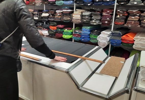 bright-colored-fabrics-on-the-counter-of-a-textile-store-fabric-in-rolls-in-a-fabric-store-fabric_t20_O0Ly4G