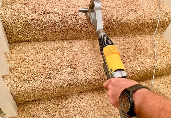 person-holding-a-suction-tube-vacuuming-the-stairs-at-home-tonythetigersson-tony-andrews-photography_t20_om644x